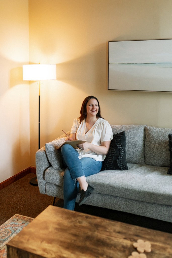 Erin sitting on a couch in her office